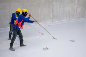 construction-worker-epoxy-painting-floor-water-proof-protection