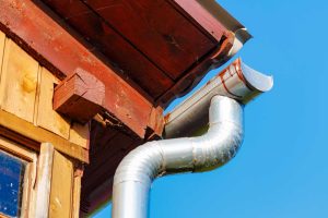 fragment-roof-village-house-with-drainpipe-closeup-against-blue-sky