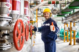 portrait-heating-plant-worker-engineer-standing-by-natural-gas-pipelines-holding-thumbs-up