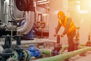 worker-opens-water-valve-chiller